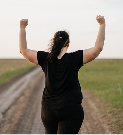 woman raising arms in victory