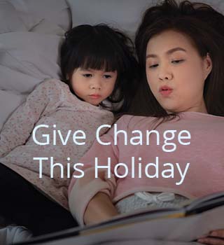 mother and daughter reading in bed